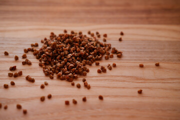 Buckwheat cereal on a wooden table. Croops close-up