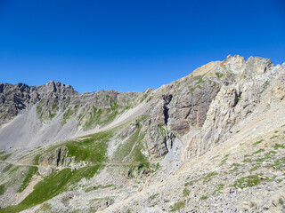 Scenic view of Monte Oserot near rifugio della Gardetta on Italy French border in Maira valley in Cottian Alps, Piedmont, Italy, Europe. Hiking on alpine pasture on sunny summer day in mountains