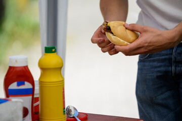 holding a sausage in a bread roll