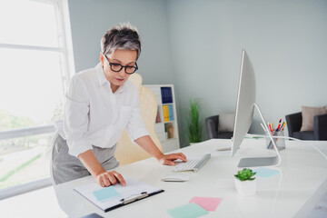 Photo of confident busy lady assistant wear white shirt reading document modern gadget indoors workplace workstation