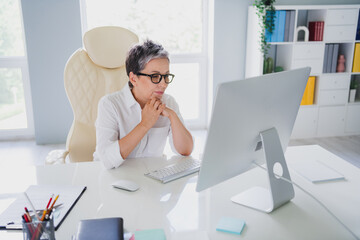 Photo of thoughtful clever lady leader wear white shirt reading messages instagram twitter telegram...