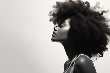 A beautiful young African American woman with curly hair and natural makeup exudes charm and style.