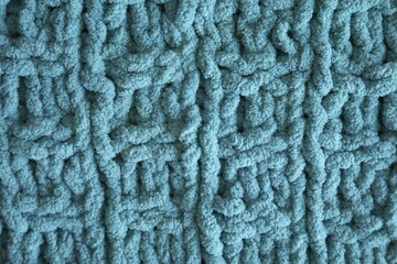 Light blue handmade knitting blanket background.