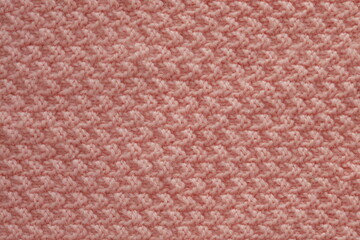 Light salmon pink handmade knitting blanket background.