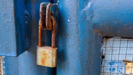 Old rusty Locked Padlock Hanging On City Park Gate