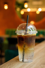 Espresso tonic iced cold refreshing drink in a takeaway glass in a coffee shop - 657272844