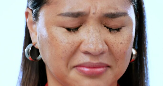 Bad smell, woman and holding nose for sweat, smelly fragrance, scent or gas in studio on blue background. Asian, portrait and person with hand on face for bad perfume or yuck reaction to body odor
