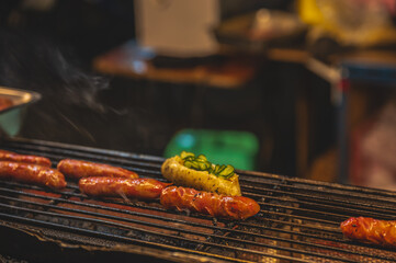 Taiwan hot dog on the stove in street food stall at liuhe night market.The Liuhe Night Market is a...