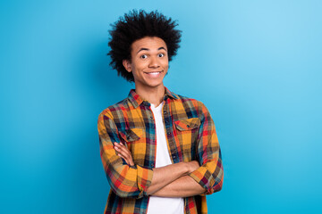 Obraz na płótnie Canvas Photo of toothy beaming optimistic guy with perming coiffure wear checkered jacket hold arms crossed isolated on blue color background
