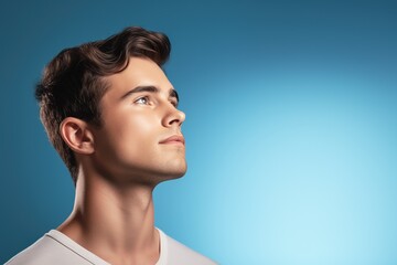 Portrait of young man. Skin care beauty, skincare cosmetics. Isolated over blue background. Copy Space. - obrazy, fototapety, plakaty