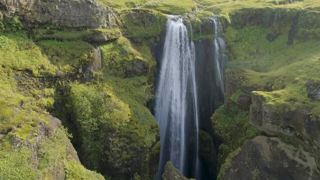 Slow forward drone flight towards the waterfall Gljufrabui in the south of Iceland