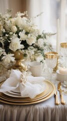 Elegant gold and white table setting with wreath and candles