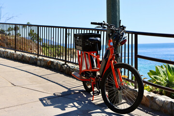 bright orange electric bike at the beach