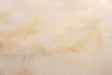 Beige, gold, ink watercolor smoke flow stain blot on wet paper grain texture background.