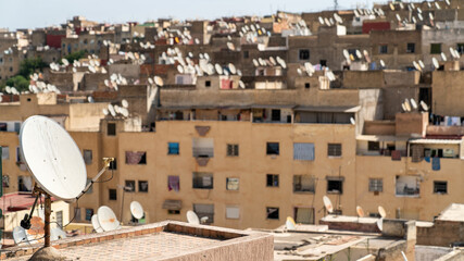 Buildings with many satellite dishes installed in Morocco. These dishes are used to receive television and other signals from satellites orbiting the Earth.