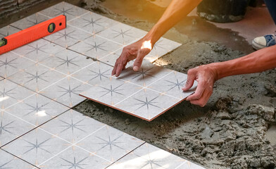 Floor tiles installation. Ceramic tiles and tools for tiler. Home improvement, renovation - ceramic...