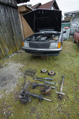 Old or vitage style car with car parts removed like shock absorbers, brake discs and suspension...