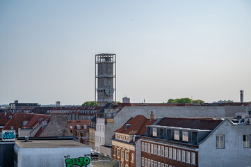 City Hall tower with clock of Aarhus, Denmark during sunset, view from distance with buildings in...