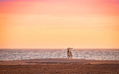Sunset, cycling on a dune facing the Mediterranean Sea, Camargue, Gard, France.