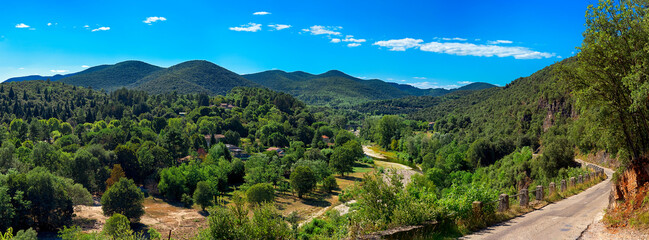 Panorama Landscape Cévennes Valley near Saint Jean. Gard. France. Europe. In the background, the Cévennes mountain range. The opportunity to walk and swim in the roach