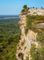 Seen on the cliff of Baux-de-Provence and tourists, Panorama of the countryside seen on the Alpilles massif. Bouches-du-Rhone, France