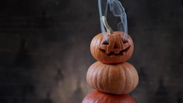 Halloween pumpkin piramid with smoke rising from eyes 