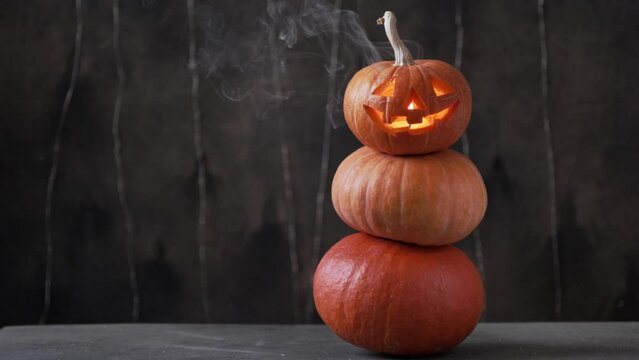 Halloween pumpkin piramid with smoke rising from eyes 