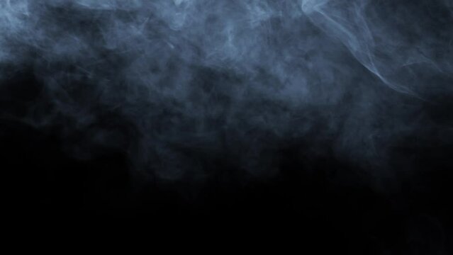 Abstract white smoke in slow motion. Smoke, Cloud of cold fog in light spot background. Light, white, fog, cloud, black background, 4k, ice smoke cloud. Floating fog.