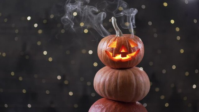 Halloween pumpkin piramid with smoke rising from eyes 