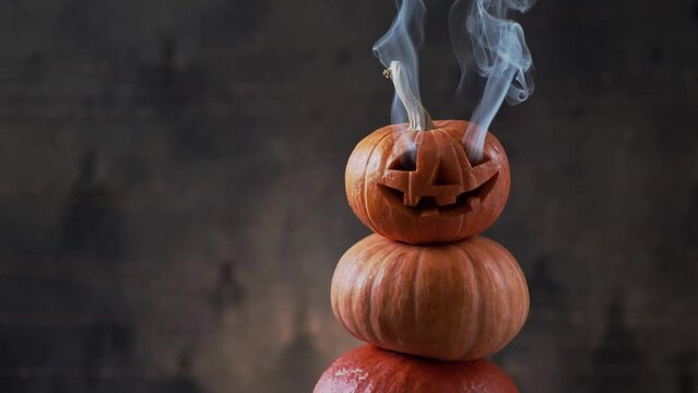 Halloween pumpkin piramid with smoke rising from eyes 