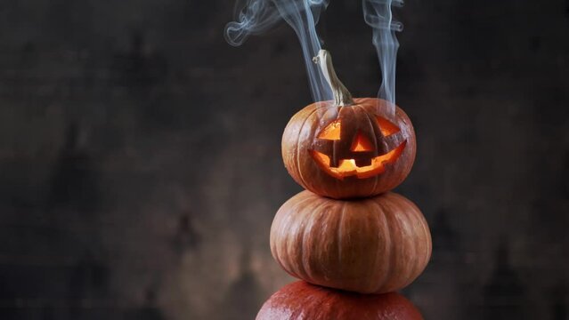 Halloween pumpkin piramid with smoke rising from eyes 