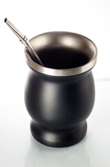 Metal calabash and bombilla on white background