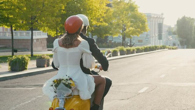 Man and woman enjoy ride on motorcycle through city streets