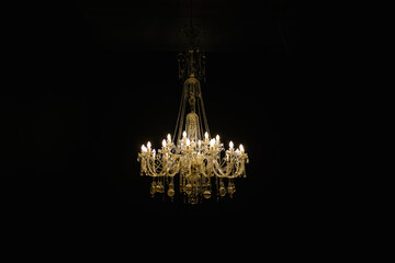 Beautiful crystal chandelier on black background. High quality photo - obrazy, fototapety, plakaty