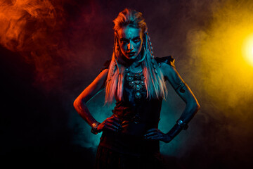 Obraz premium Photo of attractive cool mystic woman wear gothic valkyrie costume ritual isolated orange fog color background