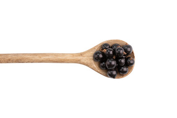 photograph of black currant berries in wooden spoon isolated on white background with clipping path, top view