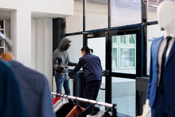 Asian manager catch robber at boutique door in shopping centre, employee asking thief to give back...