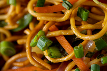 Close up of noodles, green onions, carrots