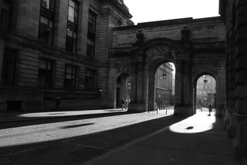 United Kingdom, Glasgow - Jan ‎2023: Black and white photograph of the city of Glasgow in the UK. Bright sunny day, play of light and shadow, illuminated historical part of the city. historical 