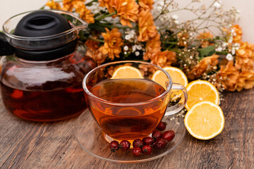 Vitamin tea made from lemons and rose hips. Herbal tea in a clear cup