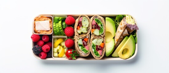 Plant based lunch for children including apple cucumber pineapple crackers yogurt blueberry and avocado wraps With copyspace for text
