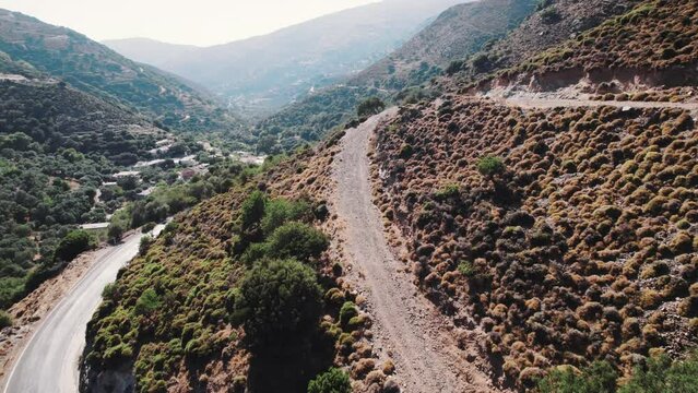 Narrow curvy road through the Topolia Gorge seen from aerial perspective. Drone flying over dangerous mountain road. High quality 4k footage