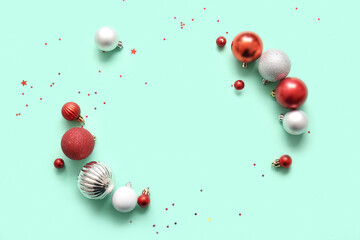Frame made of Christmas balls and confetti on turquoise background