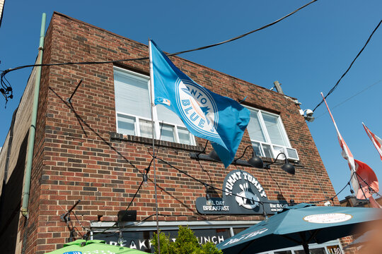 Exterior Building And Sign Of Tummy Tummy Restaurant Located At 1962 Eglinton Avenue West Toronto Canada With Flags And Sky