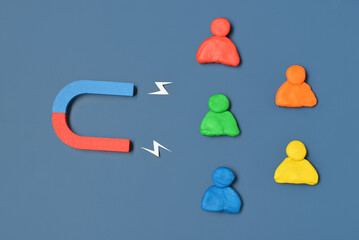 Magnet with lightnings and group of customers on blue background. Marketing concept