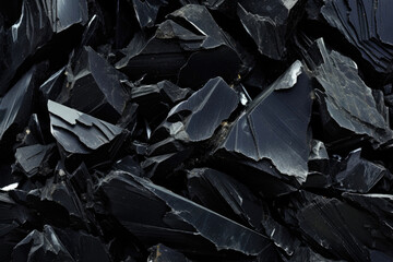 Texture of dark Volcanic Obsidian, characterized by a glossy sheen that highlights its intricate crystalline structure. - obrazy, fototapety, plakaty
