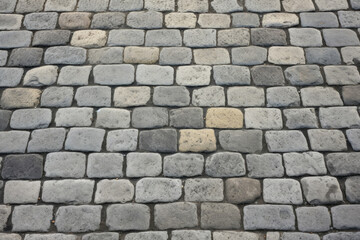 Texture of a wellmaintained cobblestone street, with tightly fitted stones and a clean, uniform surface.