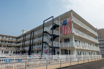 A restored motel with pool area and American Flag on the boardwalk