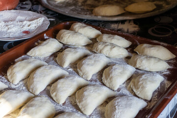 Preparation of dumplings on the table in the kitchen