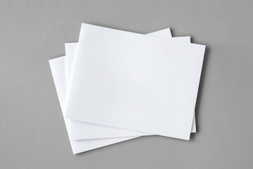 White booklets isolated on grey background. 3D render